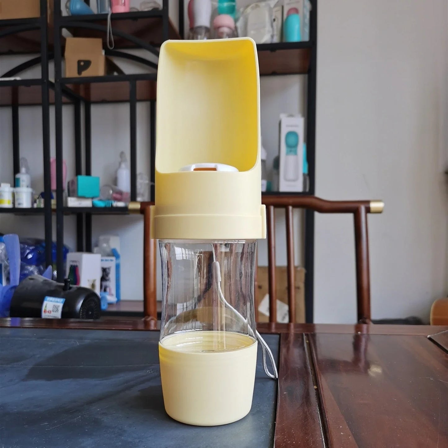 Portable 2-in-1 pet water bottle and feeder in various colors with lanyard for outdoor adventures