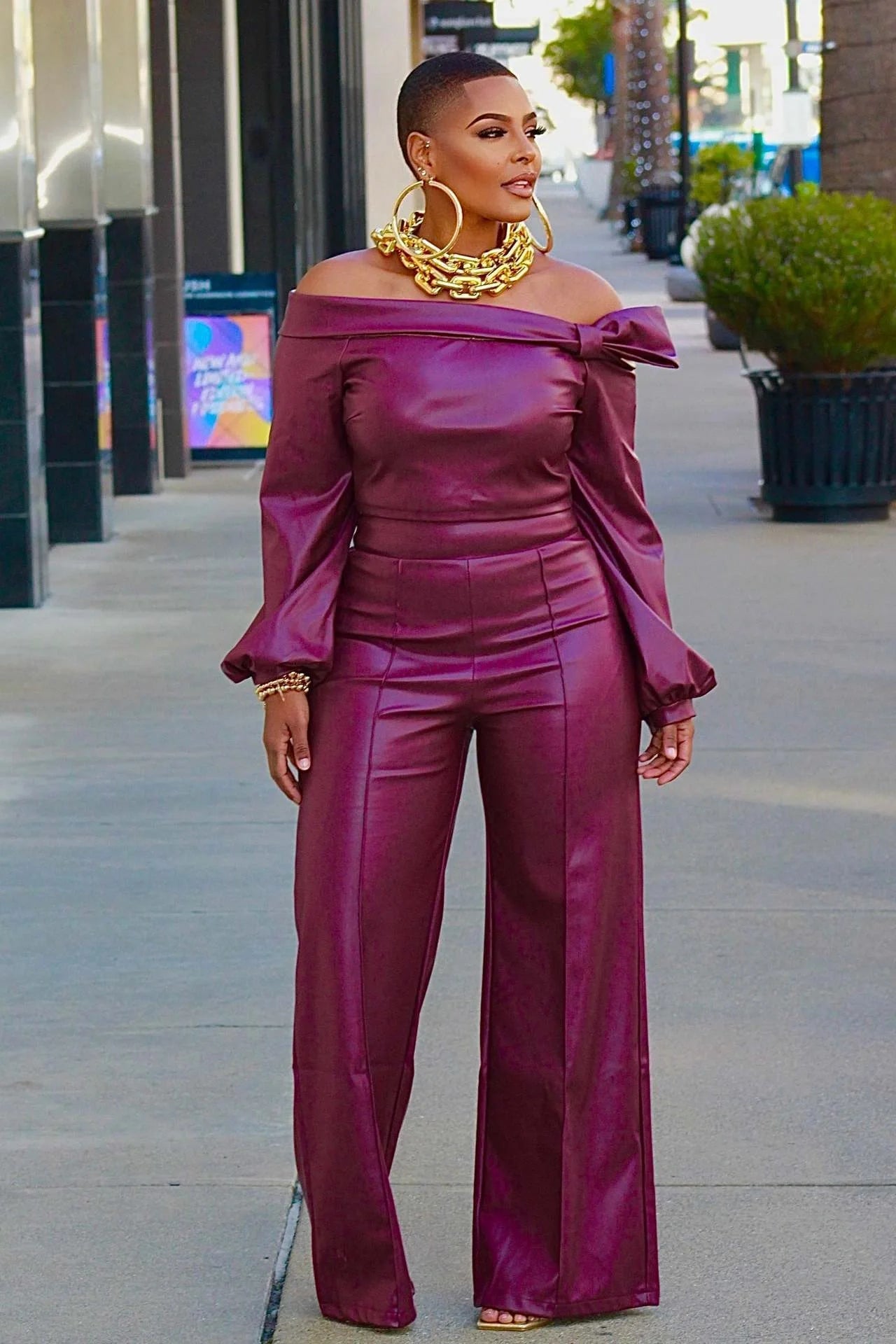 Women's wine red leather suit with detailed stitching, front and back views