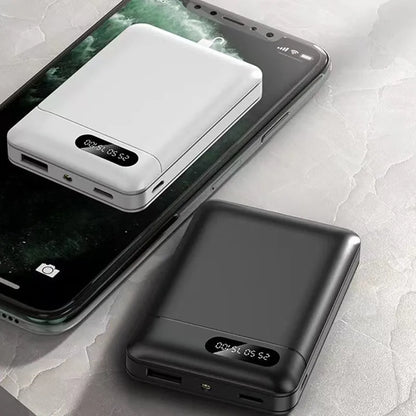 White or black large capacity portable power bank showing dimensions and USB output port.