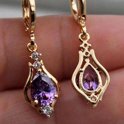 Elegant drop-shaped earrings with shimmering zircon accents in various colors, including purple, white, red, pink, and champagne