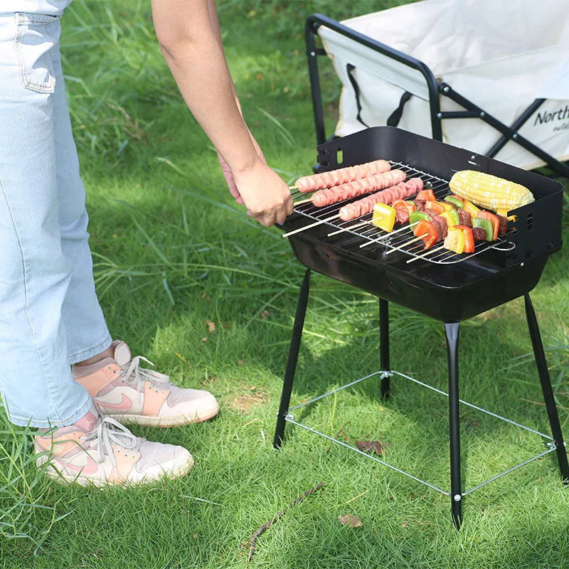 Portable outdoor barbecue oven with metal grill for camping and outdoor use