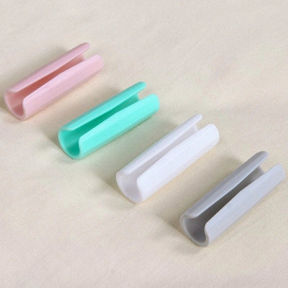 Non-slip sheet clips in various colors securing bedding neatly in place
