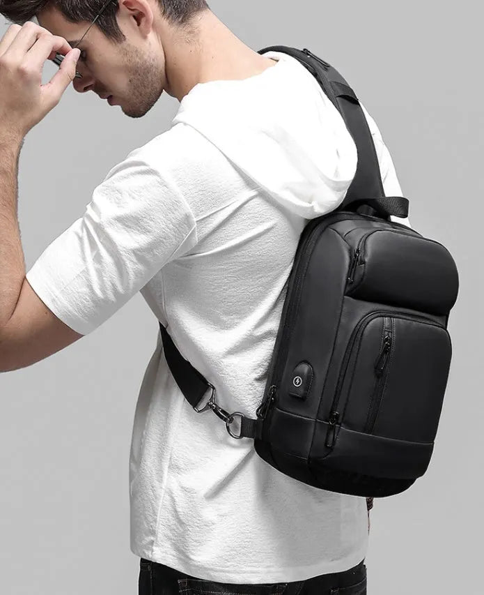 Black outdoor leisure shoulder bag with air cushion strap and multiple internal compartments