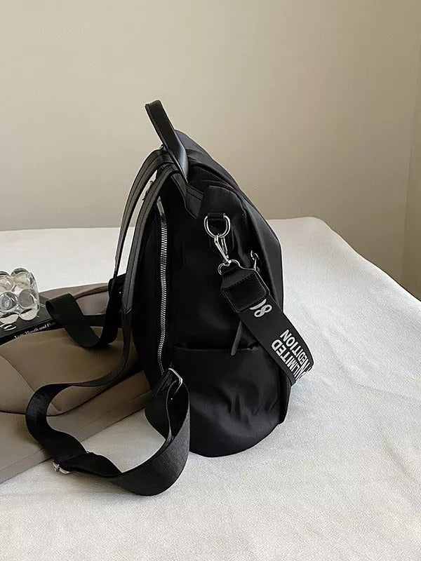 Trendy women's travel backpack in black and brown, featuring large capacity and waterproof material