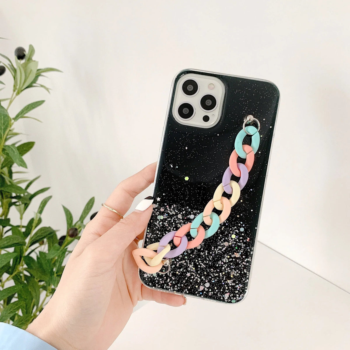 Silicone soft cover phone case with bracelet starry design in transparent, black, pink, or green for iPhone 14 and 15