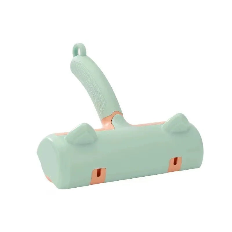Mint green plastic cat hair removal brush with an ear-style handle on a fabric sofa.