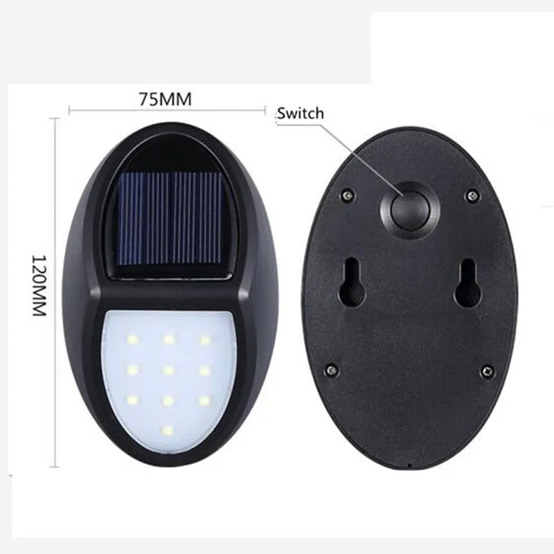 Black rectangular LED solar wall light mounted on an outdoor wall with a visible solar panel.