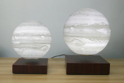 Levitating Earth or Jupiter lamp floating above base with LED illumination