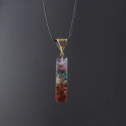 A stylish 7-chakra crystal pendant featuring a unique geometric design and natural stone patterns