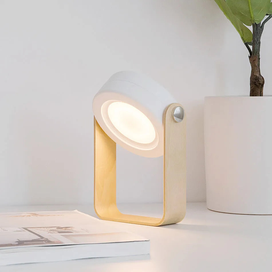 White foldable USB rechargeable LED night light in both table lamp and tall lantern modes.
