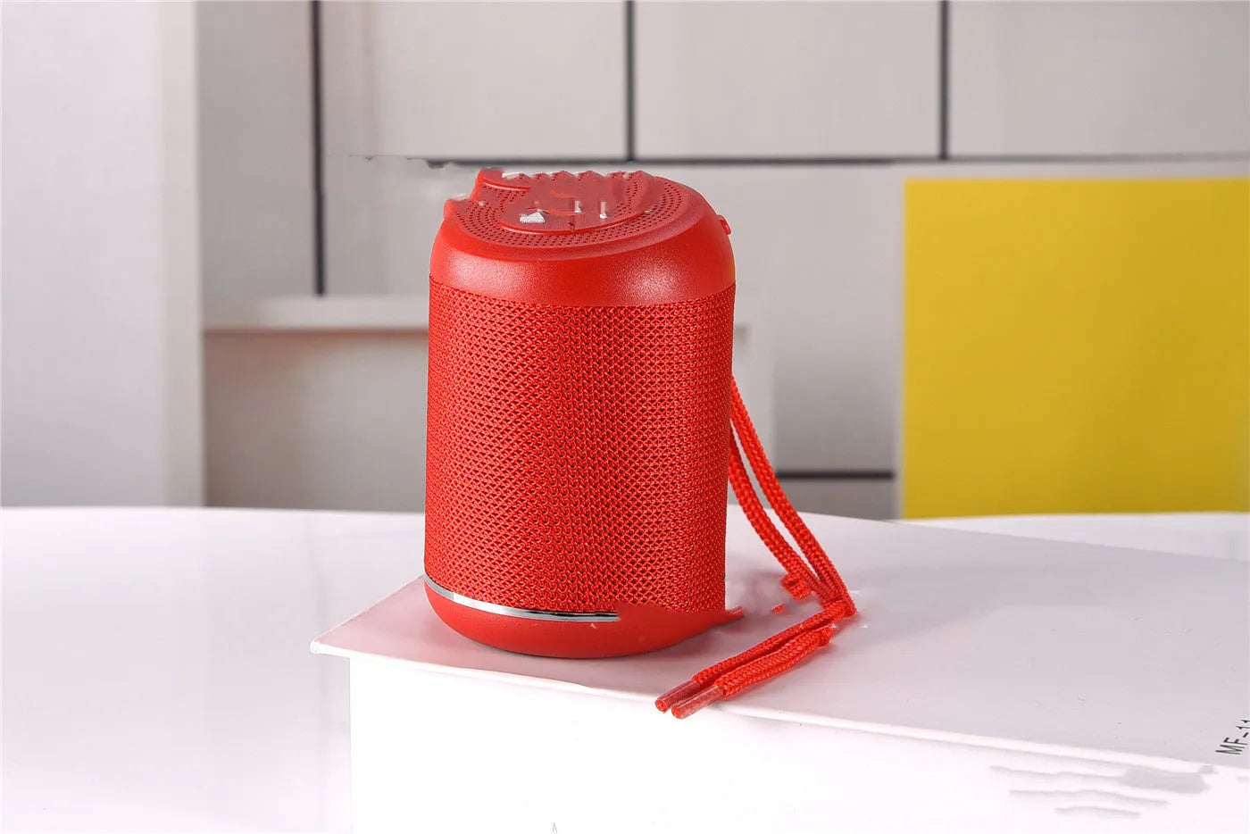 Portable outdoor Bluetooth subwoofer speaker in multiple colours showing button controls.