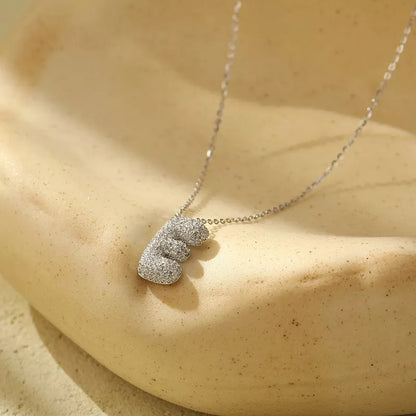 Stainless steel initial pendant necklace with zircon accents, personalized with your choice of letter.