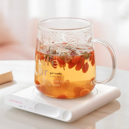 Pink and white USB heating cup pads with mechanical dials on a desk