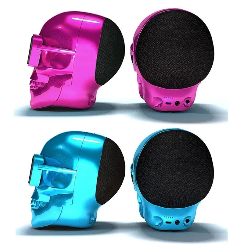 Limited edition Skull-shaped portable wireless Bluetooth speaker in various colours on a table.