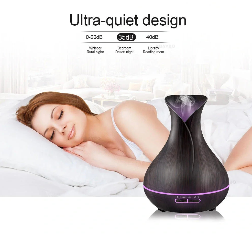 Black USB humidifier with colour-changing LED lights and water mist output, 15cm tall on wooden desk