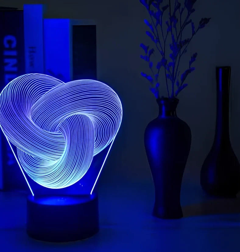 Twist abstract LED 3D night light with acrylic construction showing colour gradient illumination on dark surface
