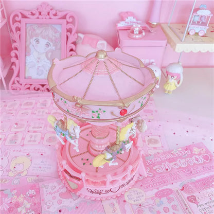 Carousel music box with pink design, clockwork movement, and light, dimensions 15.5x15.5x24 cm