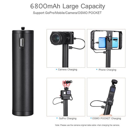 Black aluminium alloy portable power bank with an integrated carry handle, shown next to a smartphone for scale.