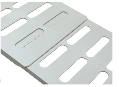 White telescopic kitchen storage rack at adjustable height on a countertop