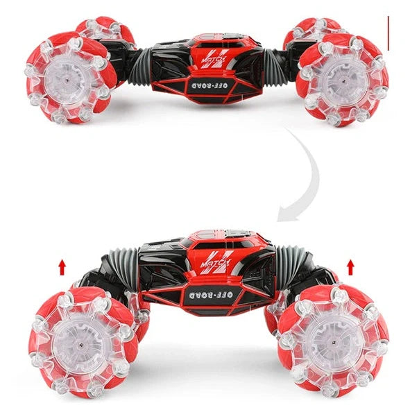 Red 4WD RC stunt car performing sideways drift with LED lights illuminated, showing gesture remote control