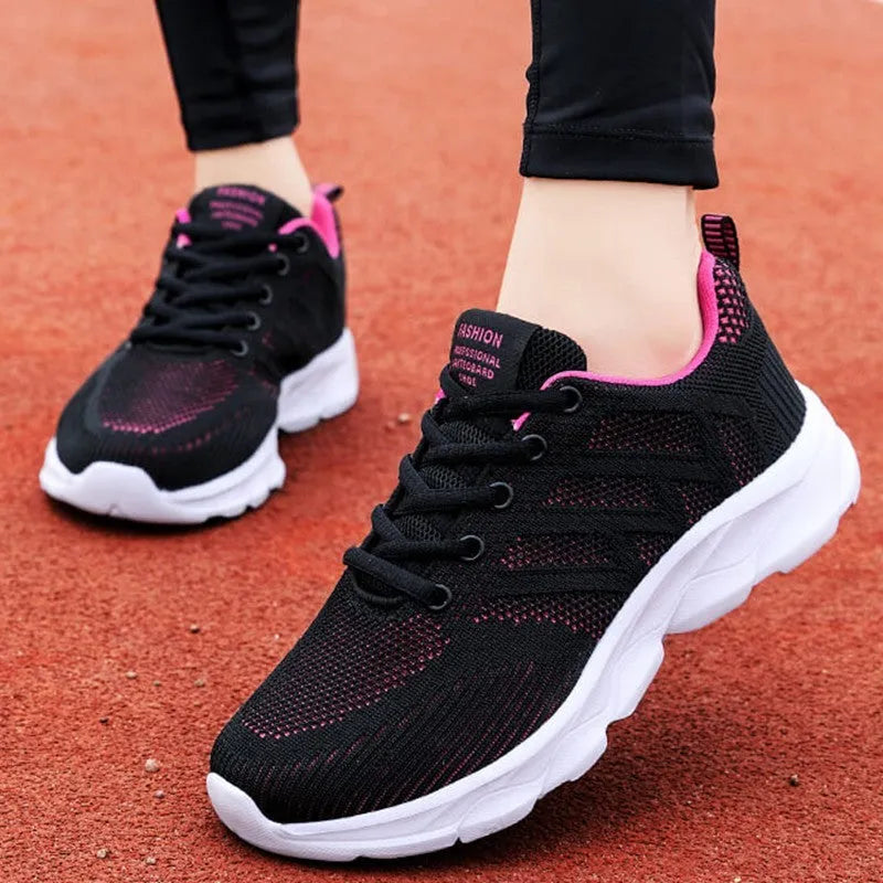 Women's white mesh fabric lace-up leisure shoes with a low heel on a plain background.