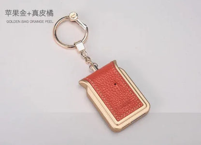 Bluetooth dual SIM adapter keychain in black leather with micro USB charging cable