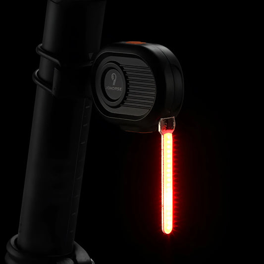 Bicycle rear safety light with a cascading waterfall LED light effect, mounted on a seat post.