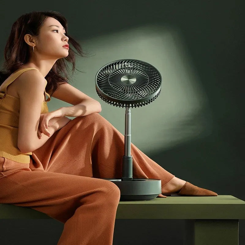Green and white storage floor electric fan extended to vertical position with remote control