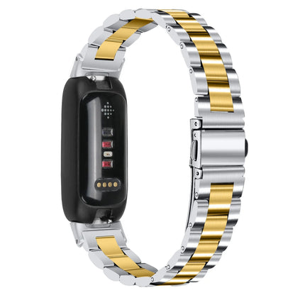 Three-bead stainless steel watch strap for Fitbit Inspire 3 in rose gold on a wrist