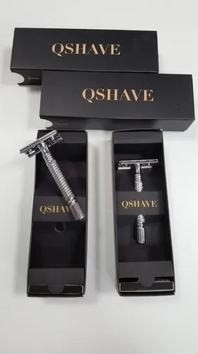 Chrome-plated double-edged safety razor with textured brass handle and storage box.