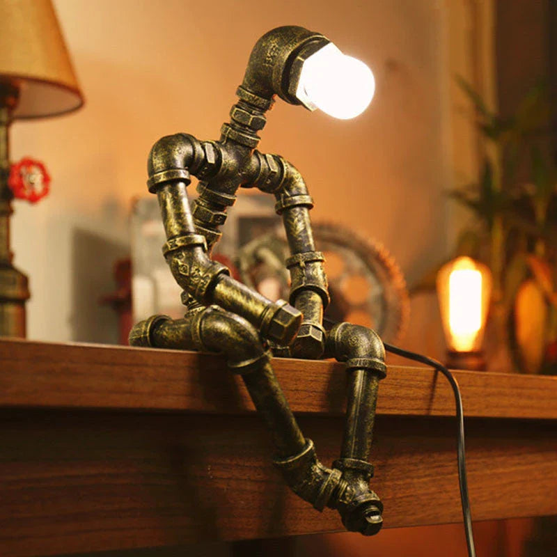 Vintage industrial iron pipe table lamp with soft, warm lighting and a green bronze finish