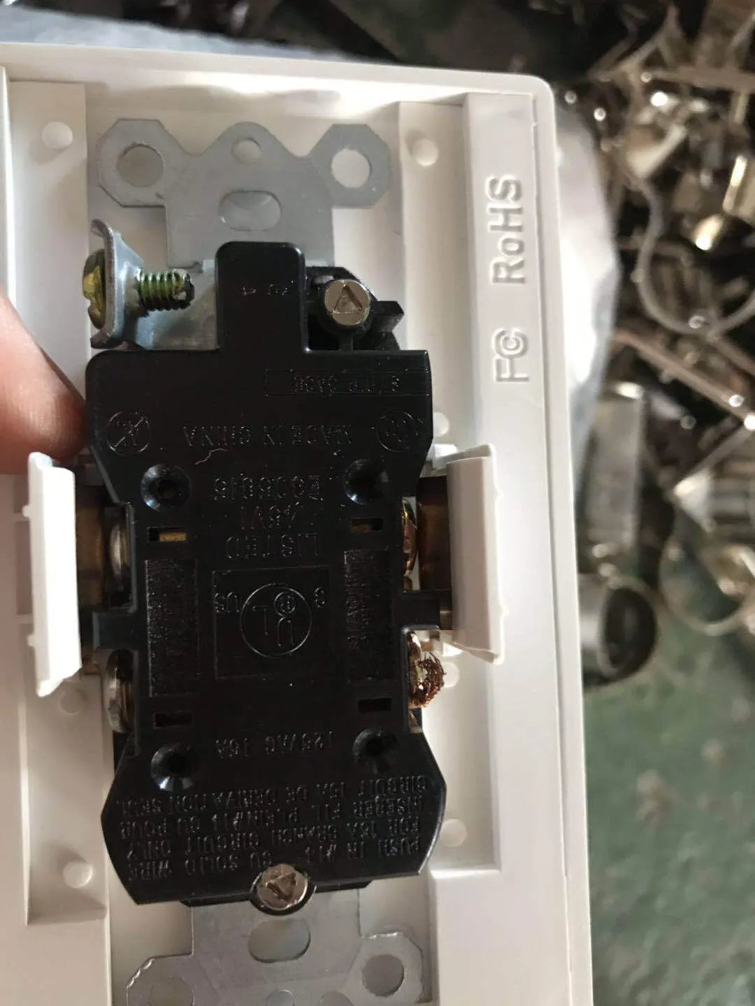 White socket induction LED night light plugged into UK wall socket with automatic sensor