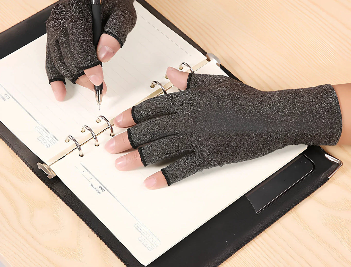 Breathable half-finger compression gloves showing exposed fingertips and adhesive grey section for joint support