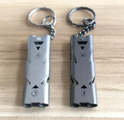 Durable metal keychain whistle in silver and black, compact design for safety