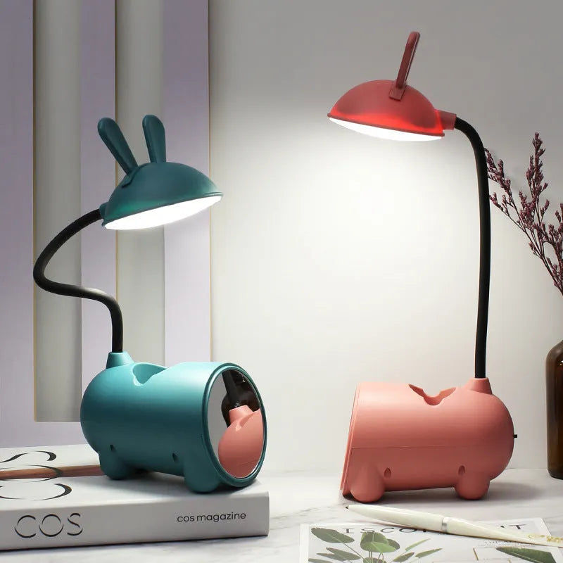 Modern green plastic USB table lamp with a long built-in pen holder on a wooden desk.