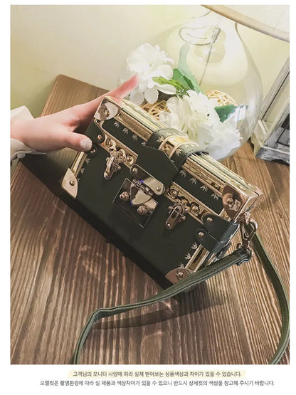 Women's hard flap shoulder bag in black or green with single adjustable strap and rivet decoration