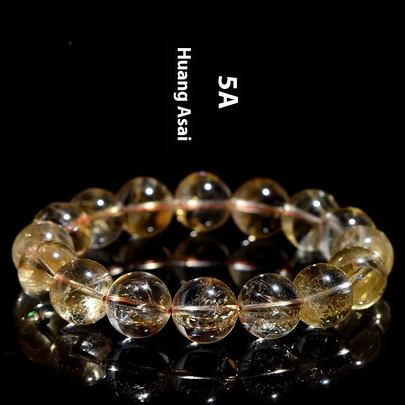 Natural yellow citrine bracelet with geometric beads in various sizes from 4mm to 20.8mm diameter on wrist
