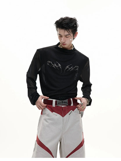 Man wearing a black slim-fit niche mesh long sleeve base layer shirt.