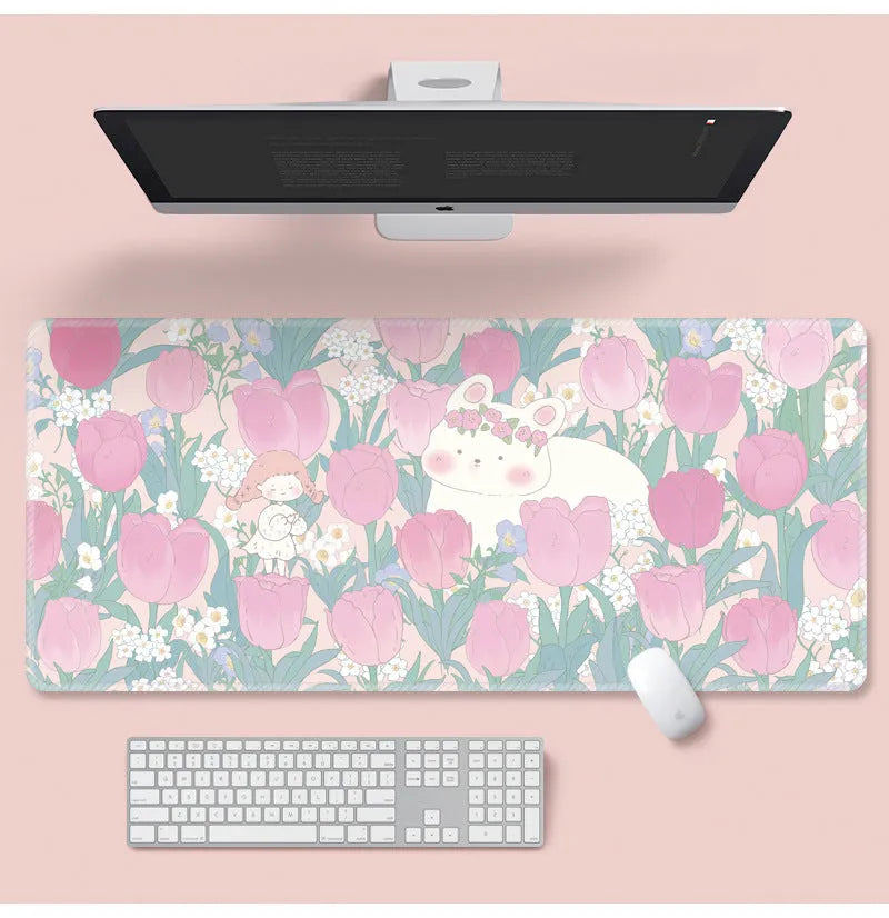 Large floral pattern mouse pad on a wooden desk with a computer mouse.