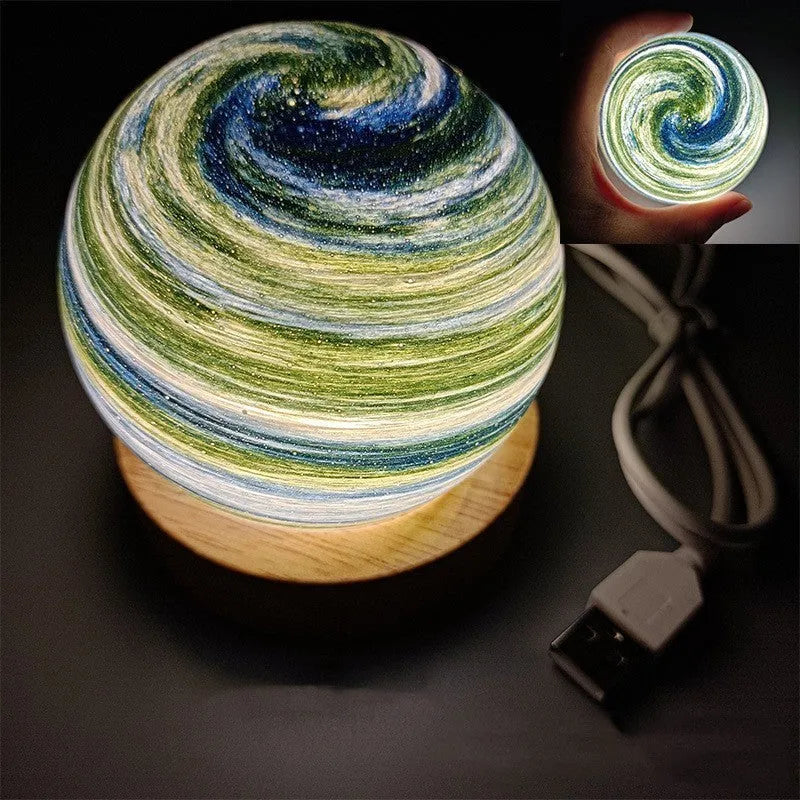 Planet-shaped USB night light with adjustable dimming in 12 colour options on its base.