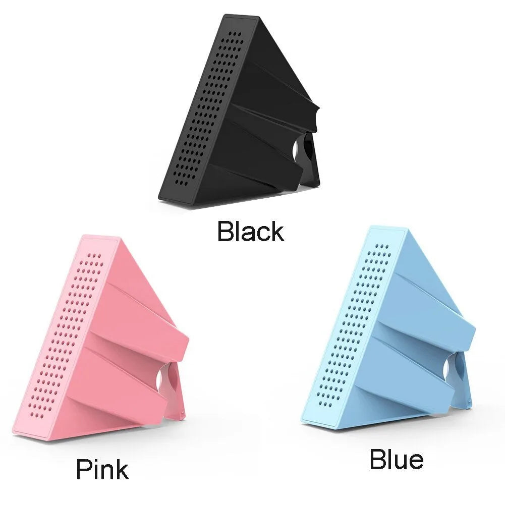 Portable black ABS plastic phone amplifier bracket holding a smartphone on a desk.