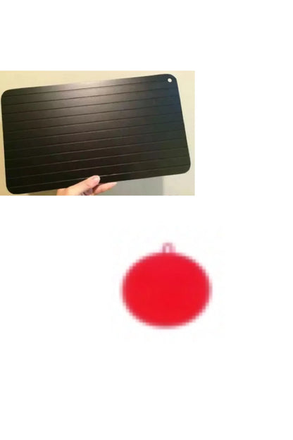 Black aluminium fast defrosting tray for kitchen use, shown thawing frozen meat.