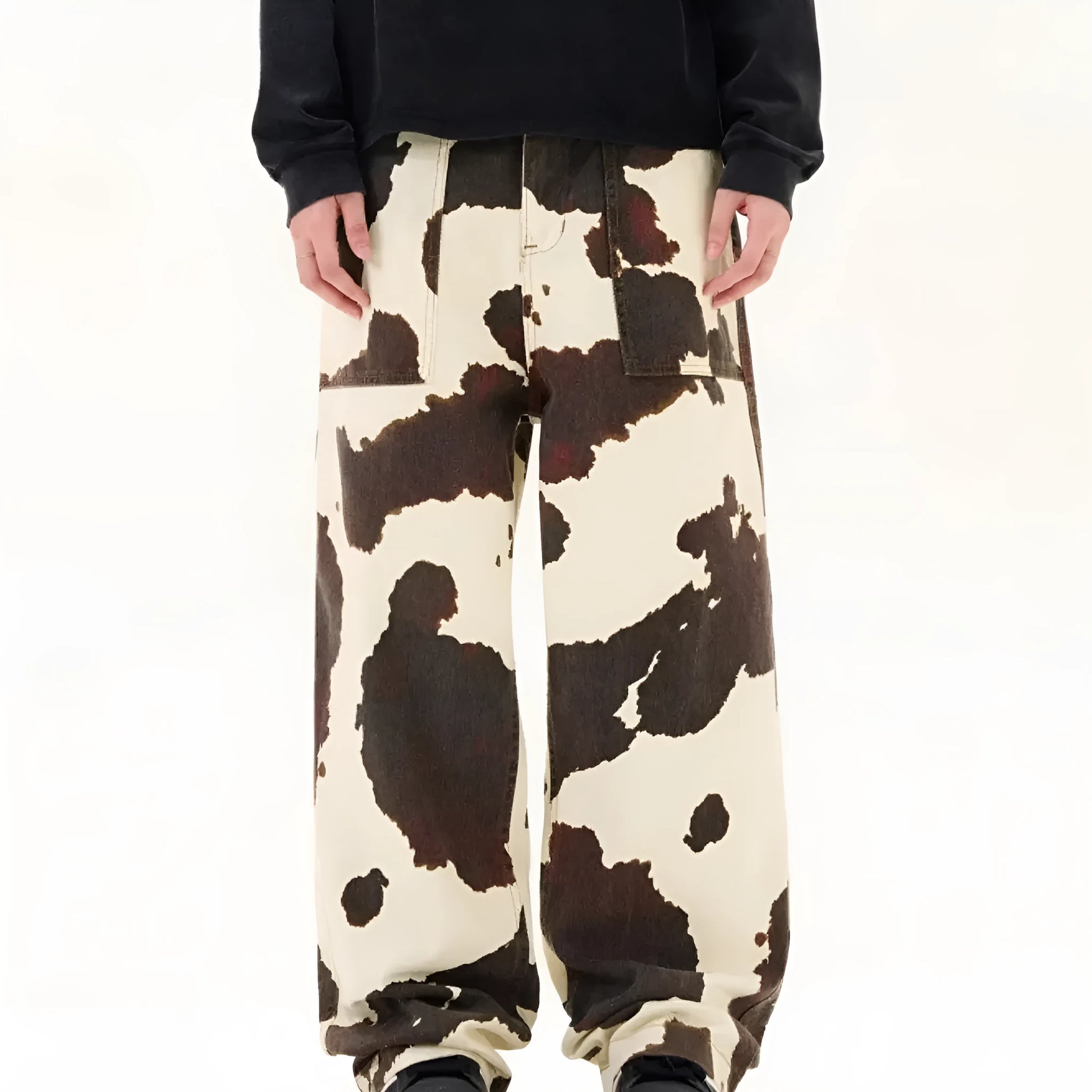Men's straight-leg trousers with a brown and white cow pattern print.