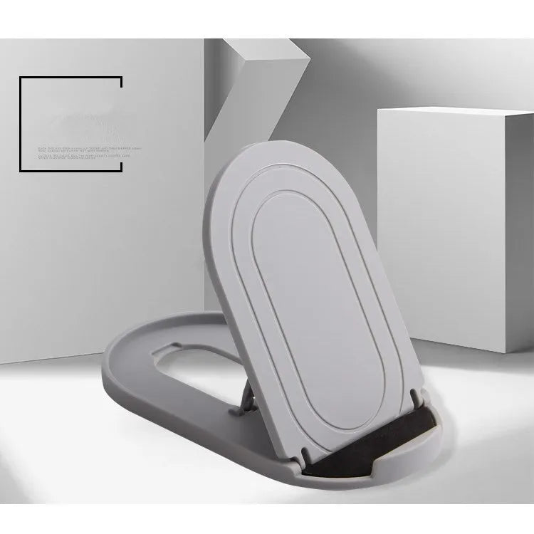 Black adjustable lazy bracket phone stand holding a mobile device at an angle on a wooden table.