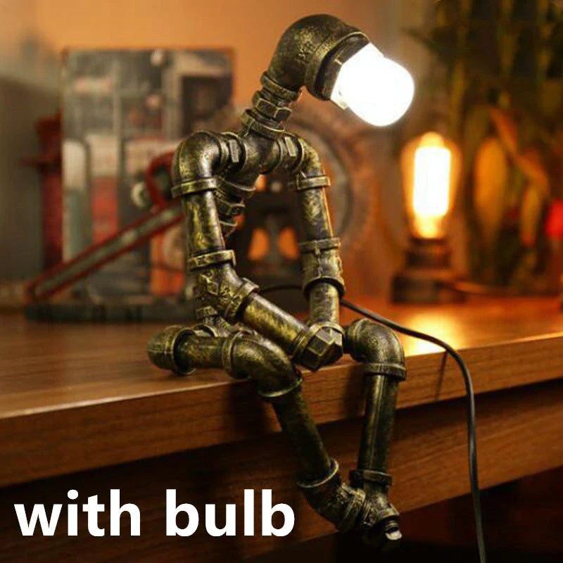 Vintage industrial iron pipe table lamp with soft, warm lighting and a green bronze finish