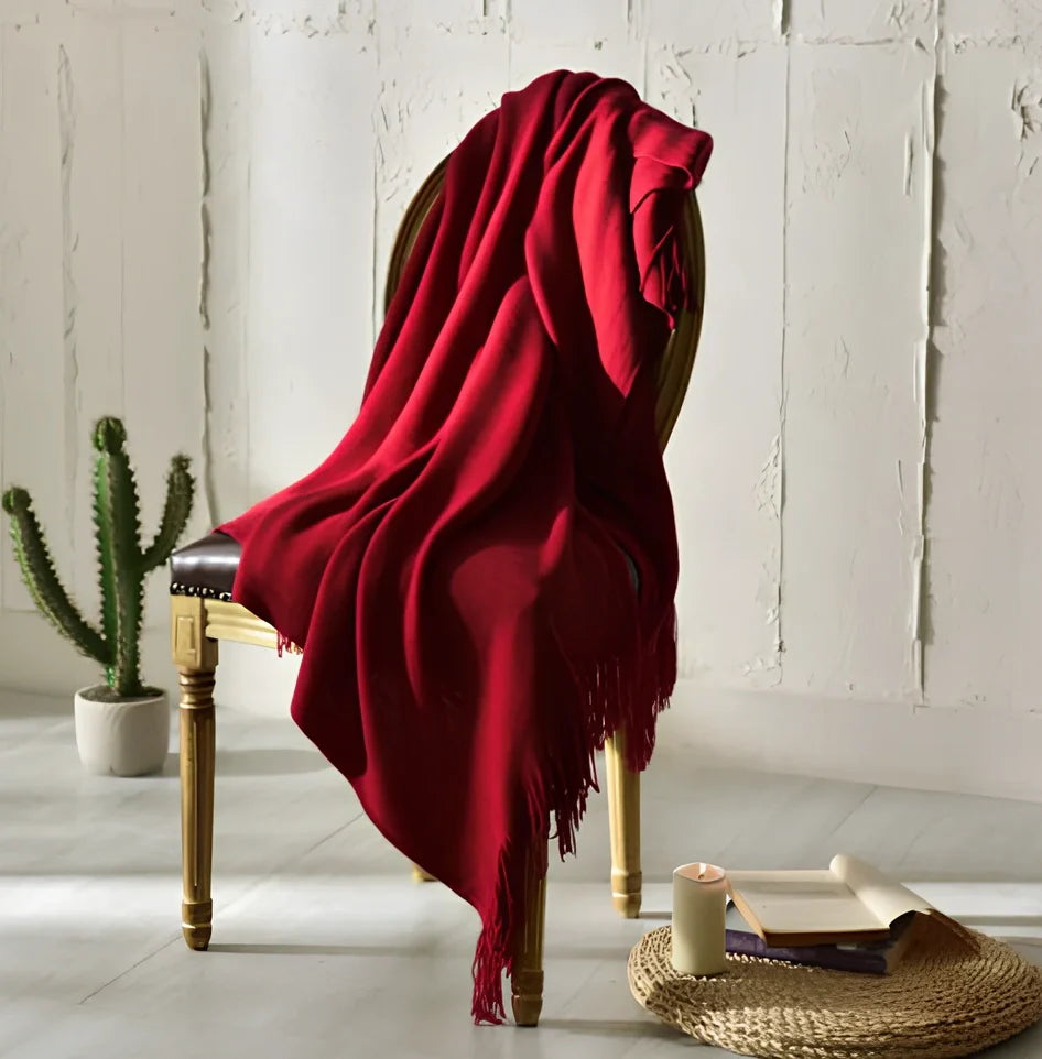 130x150cm knitted acrylic blanket with 10cm fringe detailing in beige colour draped over sofa