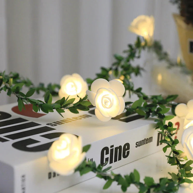 Enchanting rose vine string lights with warm white LED illumination and natural green leaves and rose buds