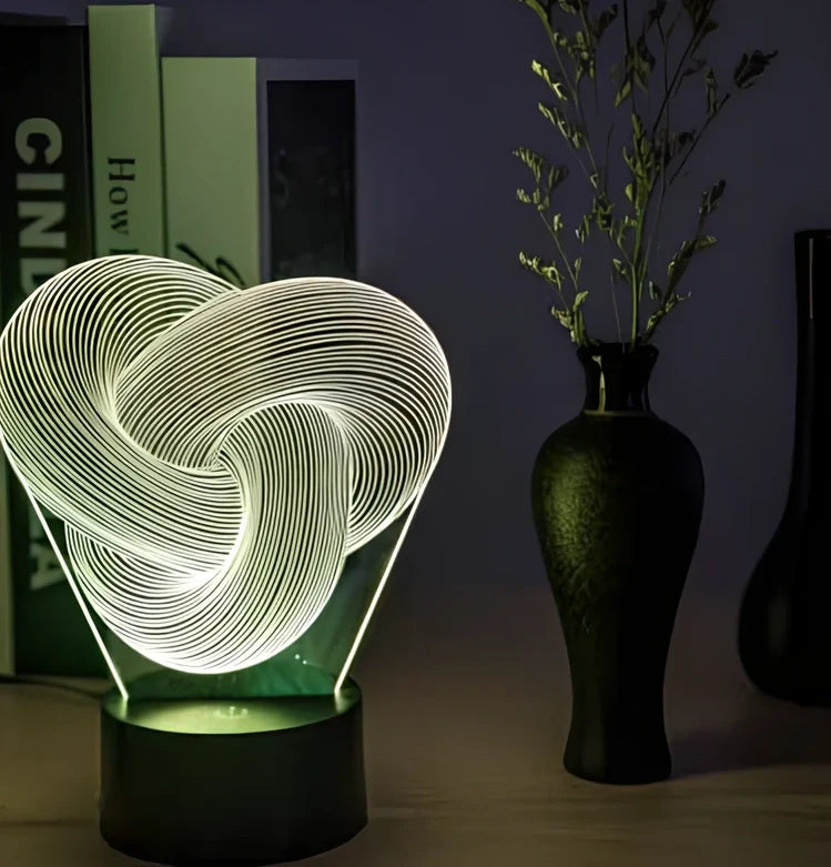 Twist abstract LED 3D night light with acrylic construction showing colour gradient illumination on dark surface