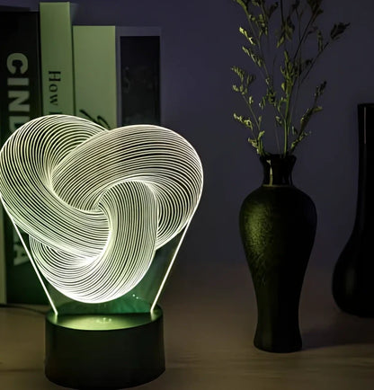 Twist abstract LED 3D night light with acrylic construction showing colour gradient illumination on dark surface