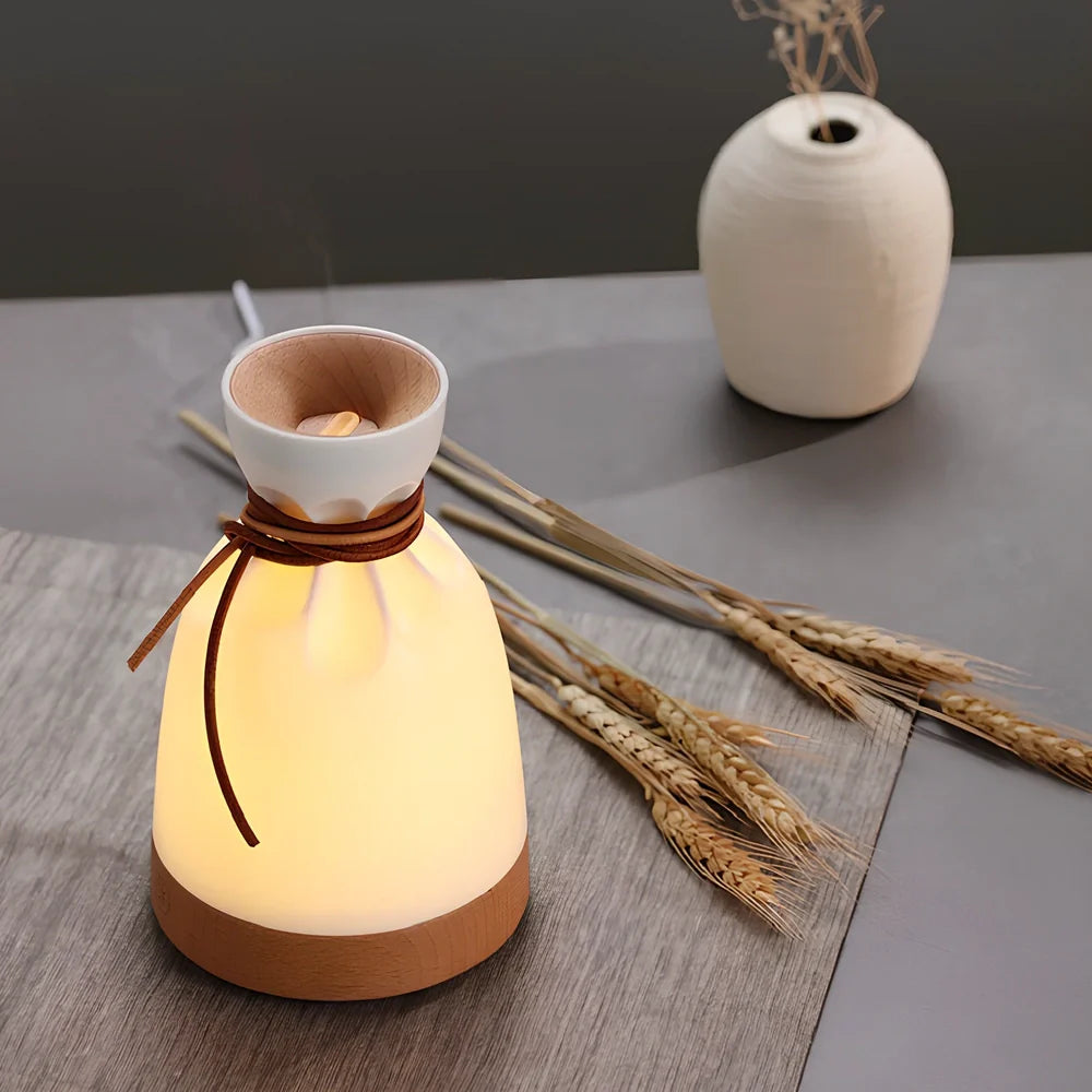 Warm yellow aromatherapy humidifier with beech wood elements and 140ml water tank capacity